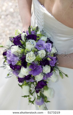 stock-photo-bride-holding-her-wedding-bouquet-with-roses-and-the-wedding-rings-on-top-of-one-rose-5173219.jpg