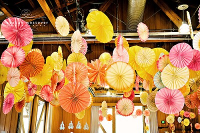 yellow-pink-orange-colorful-wedding-recipetion-decor-paper-pinwheels.jpg